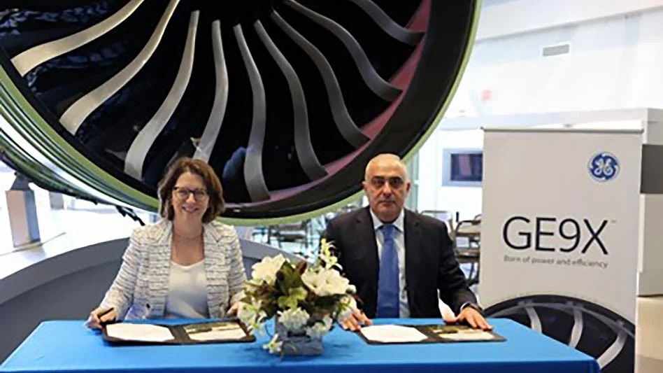 Kathy MacKenzie, president of Commercial Programs for GE Aerospace (left) and Zaur Akhundov, president of Silk Way Group, sign ceremonial documents at the GE Learning Centre in Cincinnati as part of Silk Way West's order announcement for GE9X and GE90 engines. 