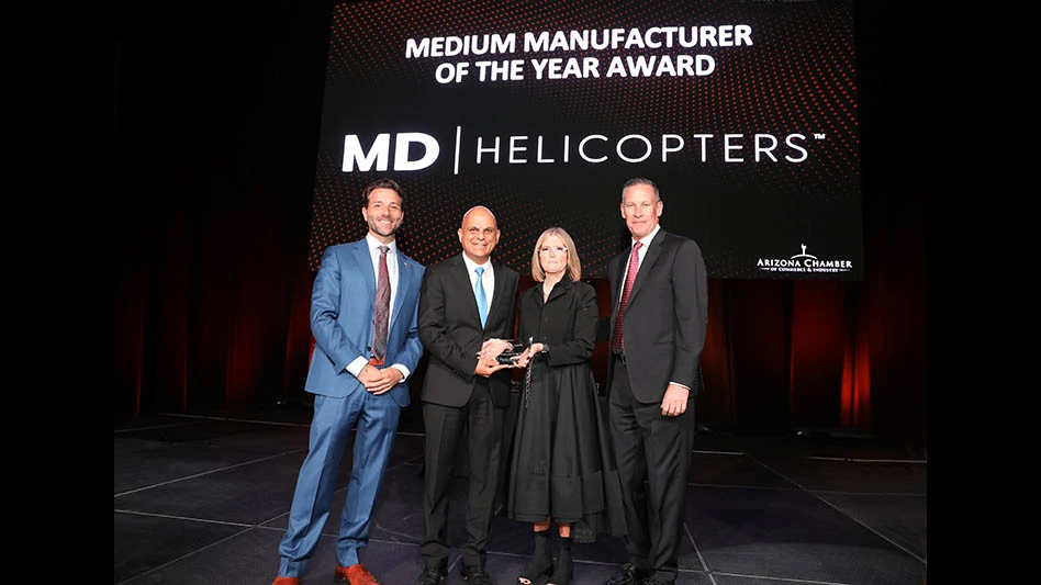 On behalf of MD Helicopters, Harvey Ticlo and Cheryl Bazzell, accept the Medium Manufacturer of the Year Award from the Arizona Manufacturers Council.