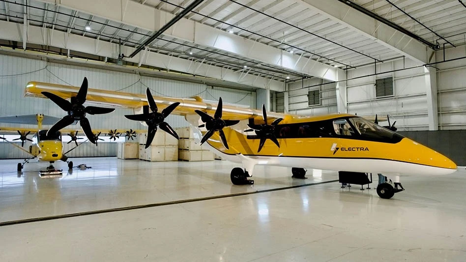 yellow electric airplane in a hangar