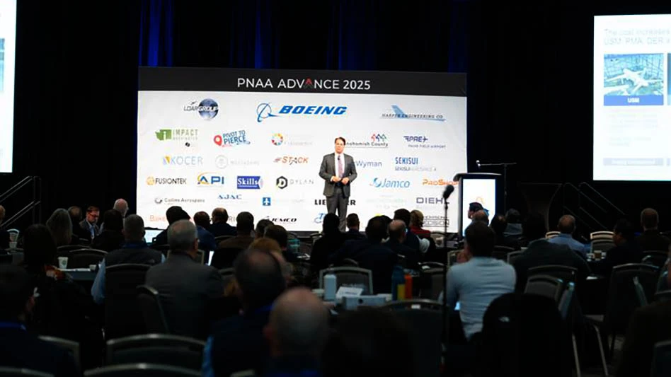 man on stage talking to an audience