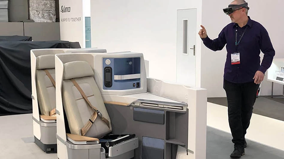 man in ar vr goggles beside airliner seat mockup