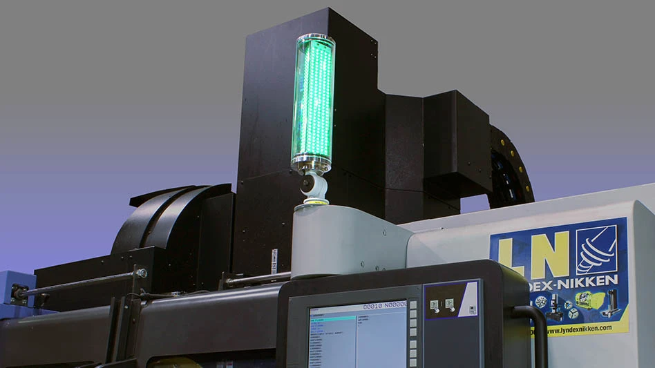 glowing green tower light atop a cnc machine tool