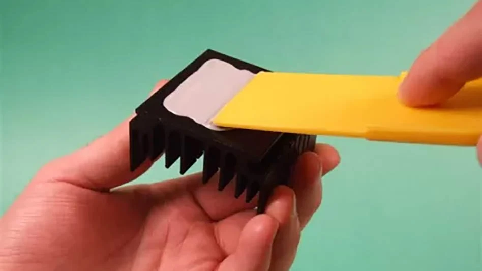 hands holding a square and applying epoxy with a spatula