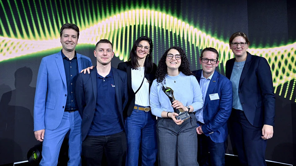 three men and three women standing in front of a screen at an awards ceremony