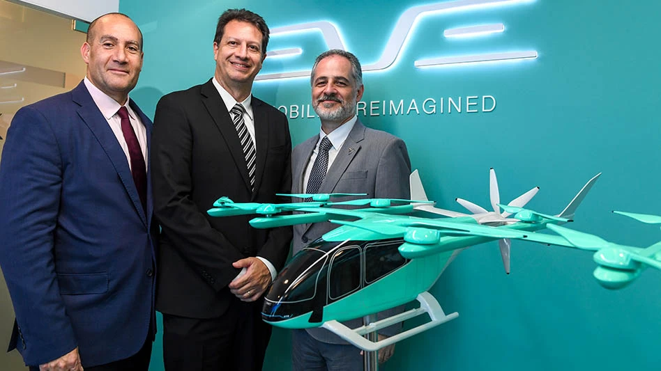 three men with a green background with an air taxi model