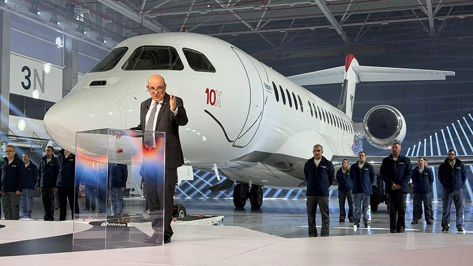 man standing in front of a business jet in a hangar